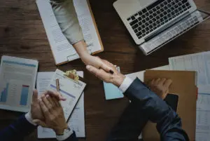 Business people shaking hands together 2