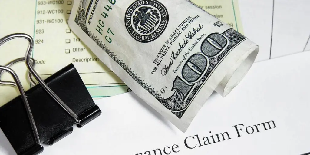 Healthcare underpayments represented by a claim form and a hundred dollar bill